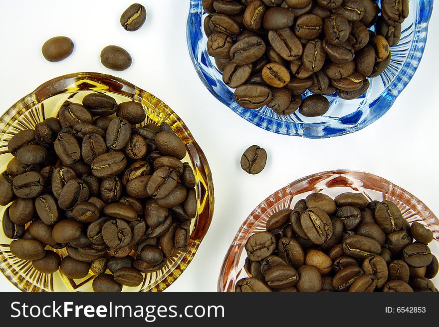 Coffee grains in colour bowls.