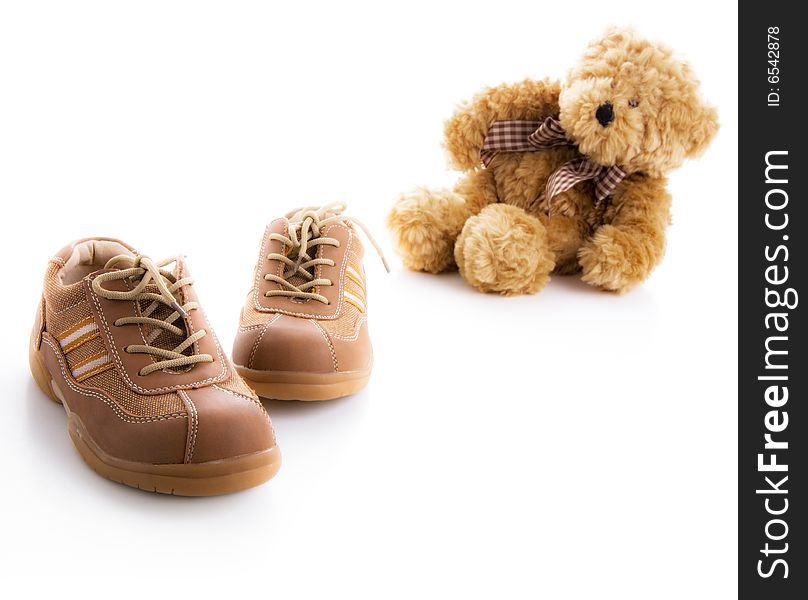 Children's brown shoes and teddy bear. Children's brown shoes and teddy bear