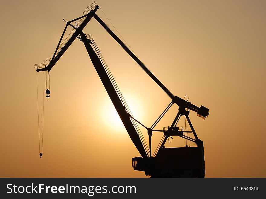 Shipyard crane silhouette at sunset. Shipyard crane silhouette at sunset