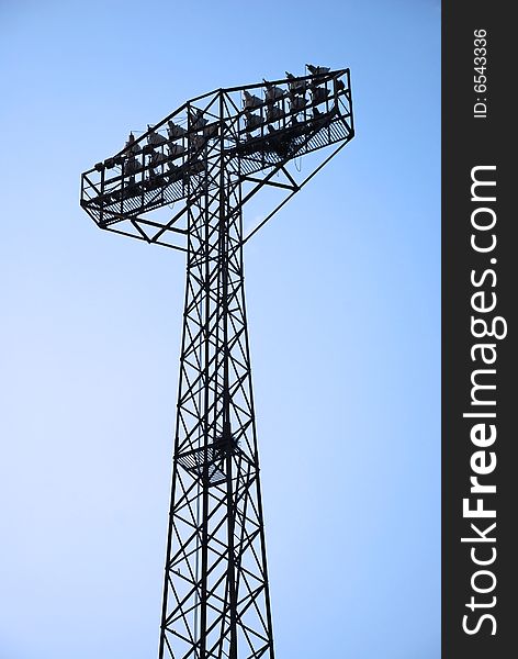 Stadium light pole at blue sky. Stadium light pole at blue sky