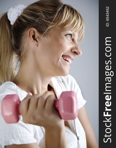 Smiling Female With Dumbell