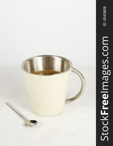 Metal mug and coffee spoon with clipping path