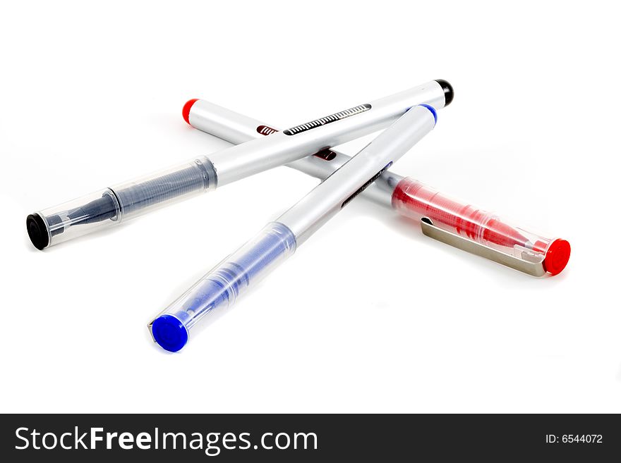 Red, blue and black pens on the white background. Red, blue and black pens on the white background