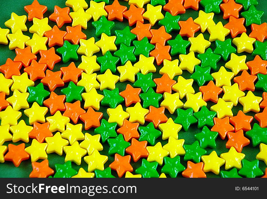 Green orange and yellow candy stars. Green orange and yellow candy stars