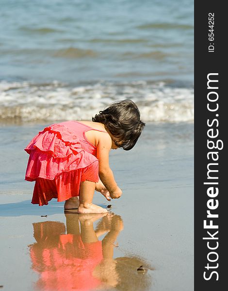 Girl playing and enjoying a summer day at the beach. Girl playing and enjoying a summer day at the beach.