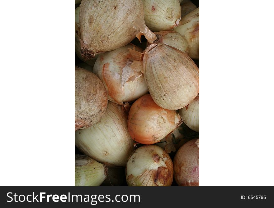 Several brown onions stacked in a pile. Several brown onions stacked in a pile.