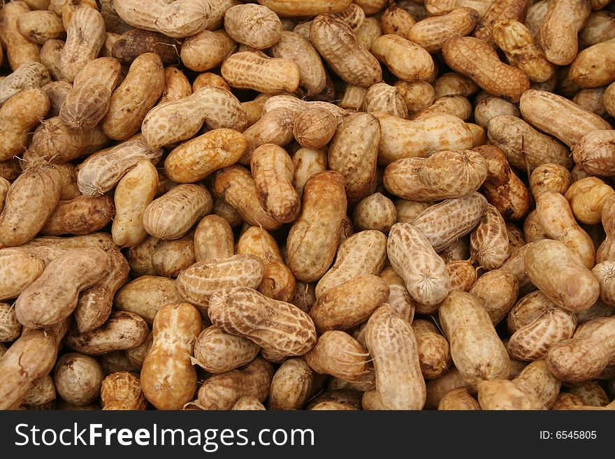 Pile of unshelled peanuts at a produce market.