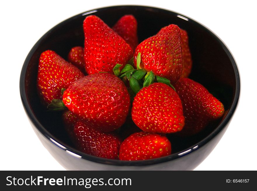 A bowl of bright red strawberries. A bowl of bright red strawberries