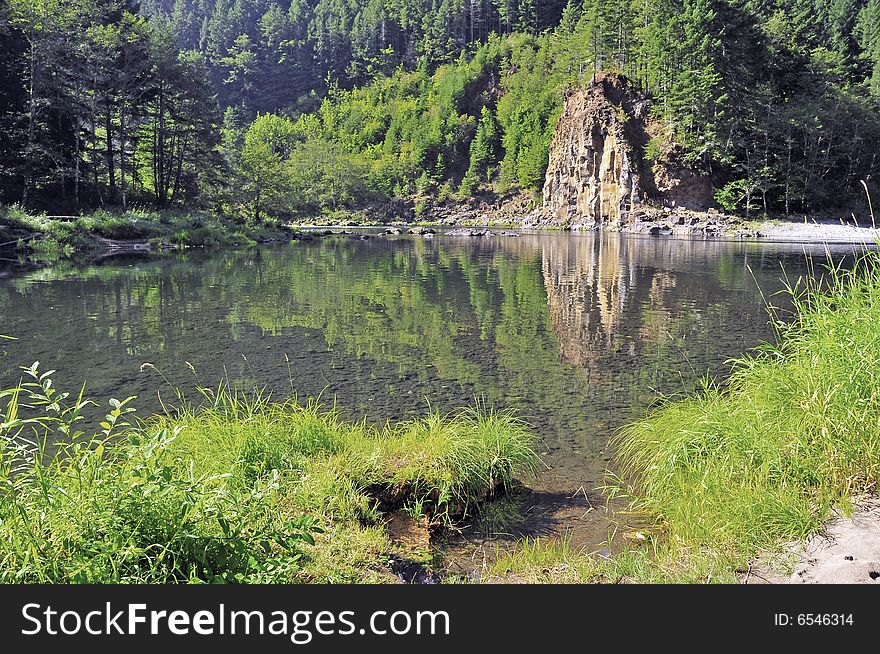 Rock's reflection in the creek of the mountain