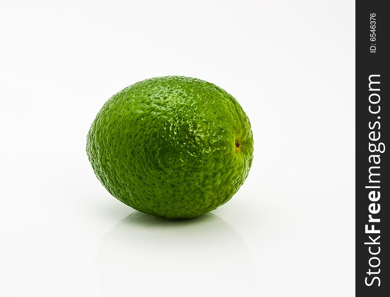 A fresh green lime on a white background. A fresh green lime on a white background