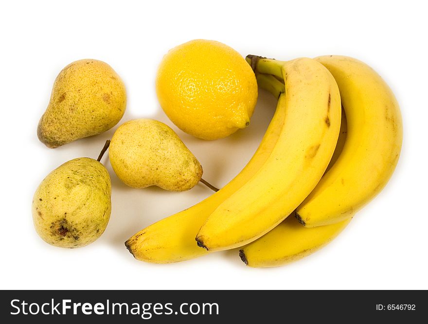 Ripe beautiful juicy yellow fruit of pear bananas lemon on white background