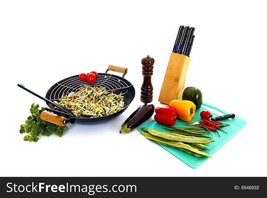 Preparing wok with fresh vegetables on cuttingboard, white background,