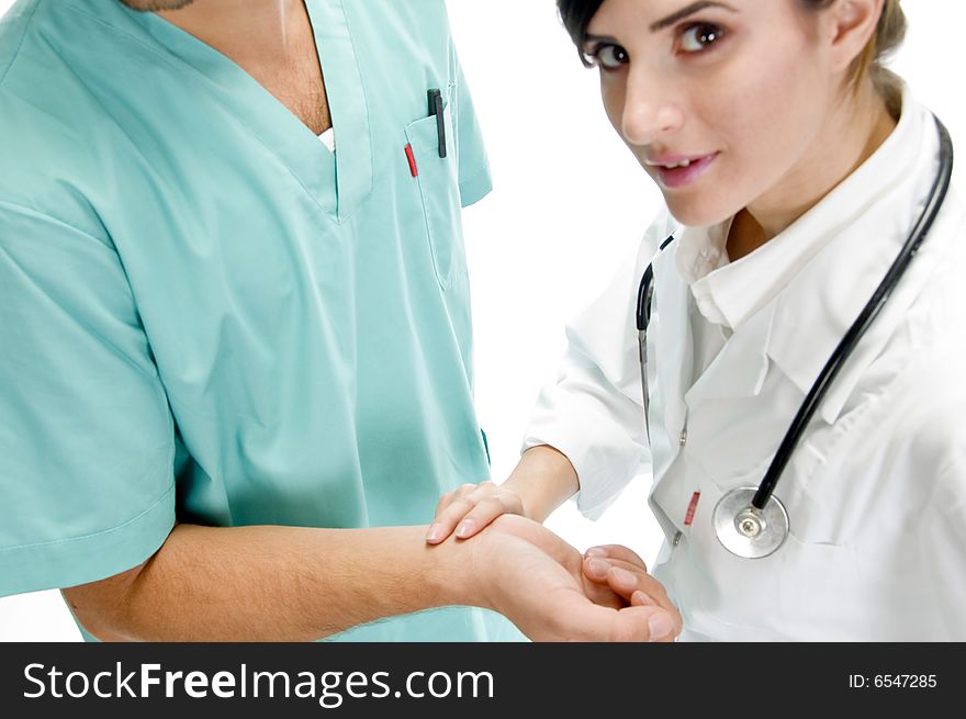 Young nurse checking pulse of patient with white background