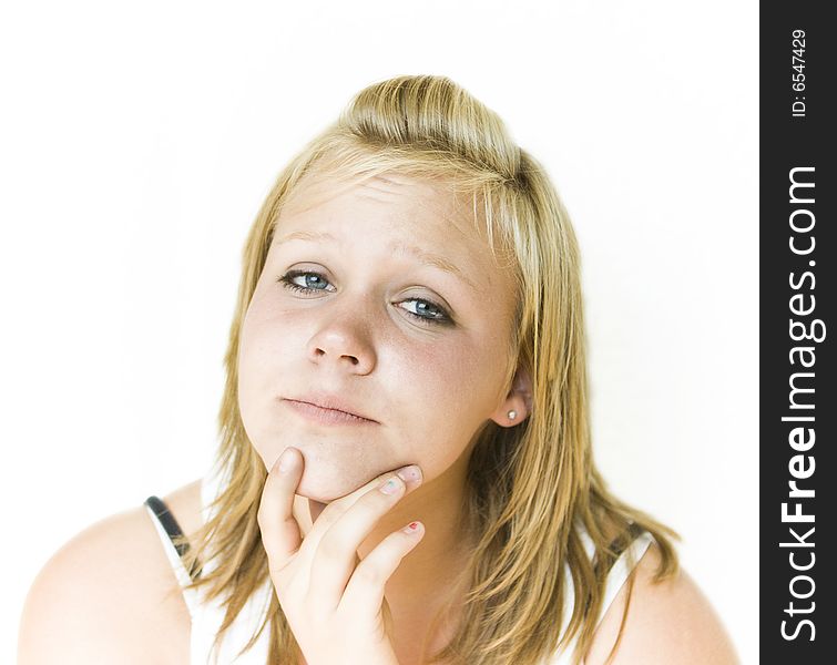 Young teenage girl looking at the camera with a thoughtful expression. Isolated on white background. See my portfolio for other expressions in this series. Young teenage girl looking at the camera with a thoughtful expression. Isolated on white background. See my portfolio for other expressions in this series.