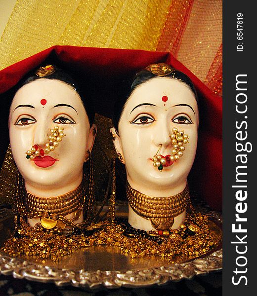 Face masks of Indian Goddess, gauri decked up with a lot of gold jewelery. Face masks of Indian Goddess, gauri decked up with a lot of gold jewelery