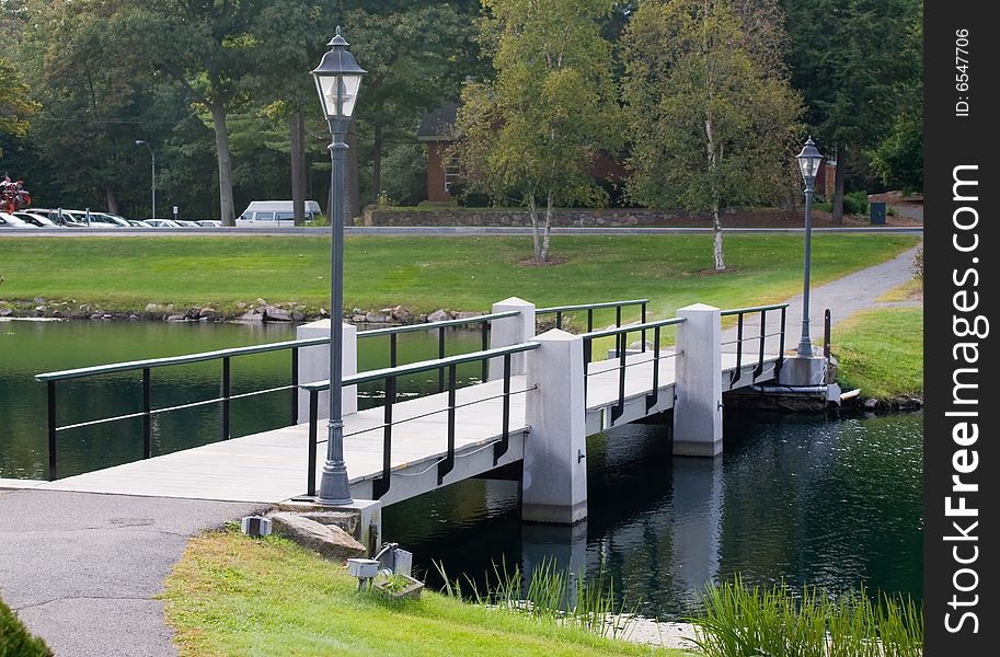 Foot bridge over the pond  in  Beverly, Massachusetts. Early fall when the trees are beginning to change colors.