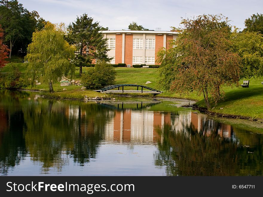 Building reflected in pond in Beverly, Massachusetts. Early fall when the trees are beginning to change colors. Building reflected in pond in Beverly, Massachusetts. Early fall when the trees are beginning to change colors.