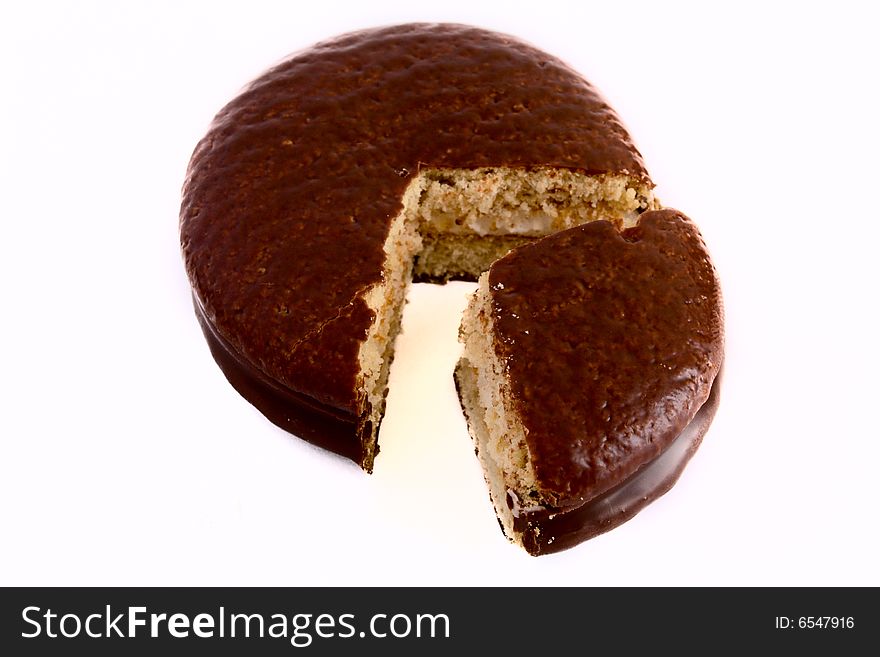 Cookies in chocolate glaze with the cut out sector on a white background