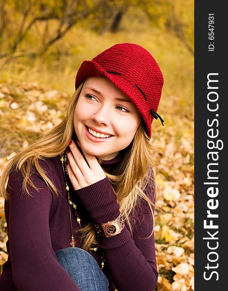 Pretty girl wearing a red hat in the park. Pretty girl wearing a red hat in the park