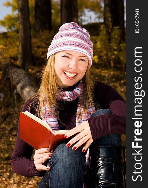 Girl reading a book in the park