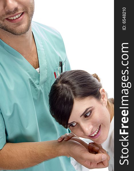 Smiling nurse checking pulse of patient on an isolated white background