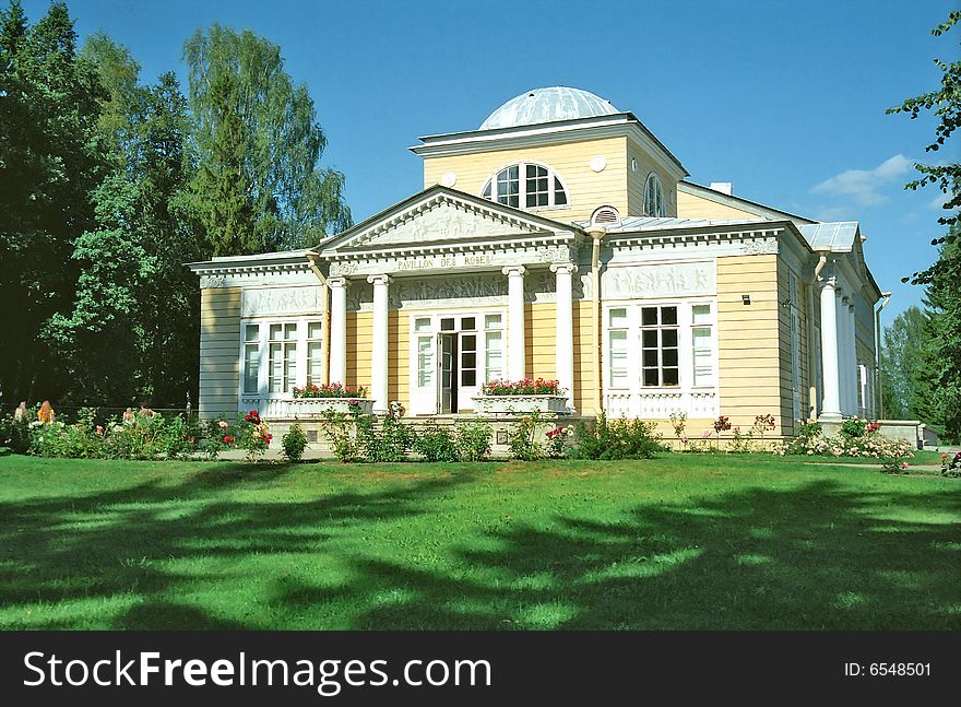 Wooden building in classical style in summer day