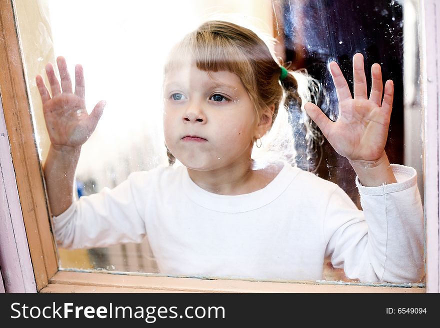 Portrait of a young girl  stands outside the window. Portrait of a young girl  stands outside the window.