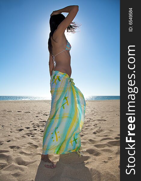 Woman with beach wrap at el palmar beach in cadiz spain. Woman with beach wrap at el palmar beach in cadiz spain