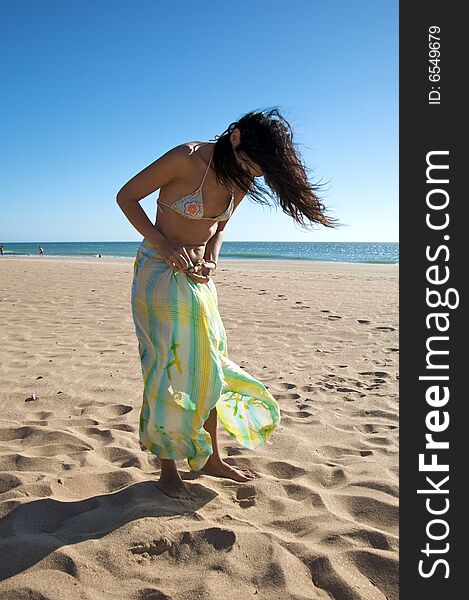 Woman with beach wrap at el palmar beach in cadiz spain