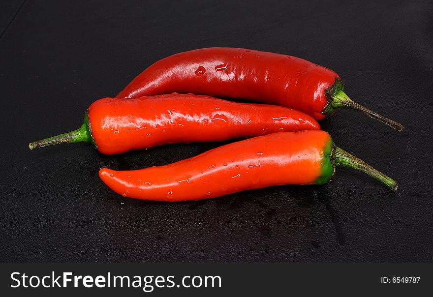 Red peppers on a dark background