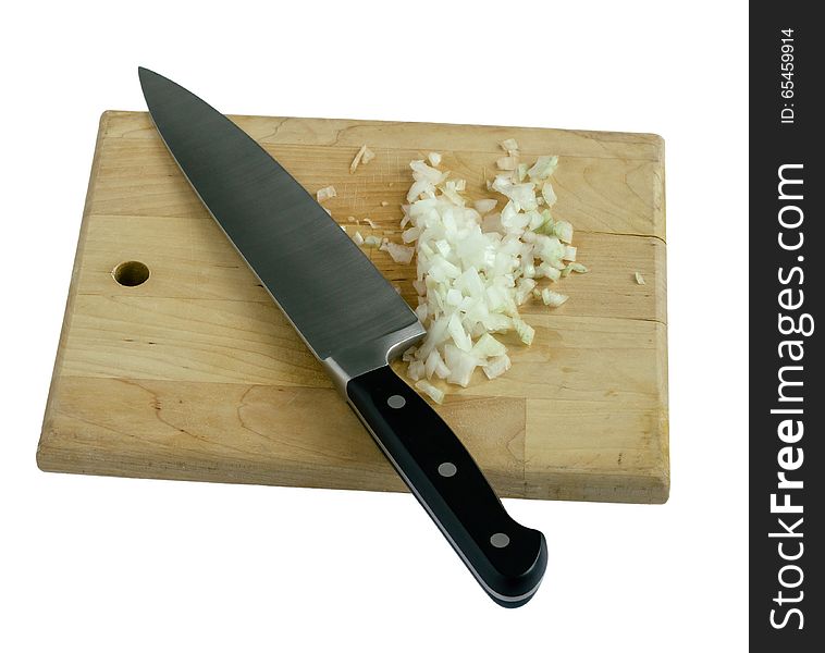 Chopped onion on a wooden cutting board with a chef's knife isolated on white background