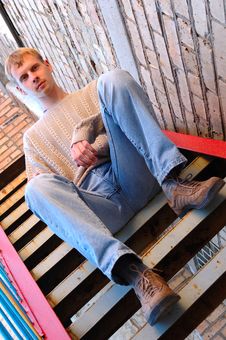 Young Stylish Man Sit On Stairs Near Brick Wall. Royalty Free Stock Image Young Stylish Man Sit On Stairs Near Brick Wall. Royalty Free Stock Image