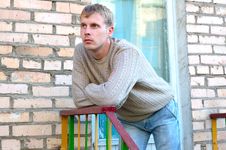 Young Stylish Man Stay On Stairs Near Brick Wall. Royalty Free Stock Photography Young Stylish Man Stay On Stairs Near Brick Wall. Royalty Free Stock Photography