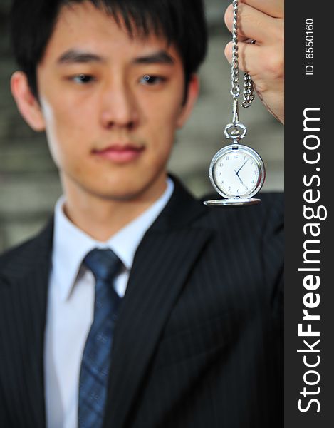 Picture of an Asian Man with pocket watch. Picture of an Asian Man with pocket watch.