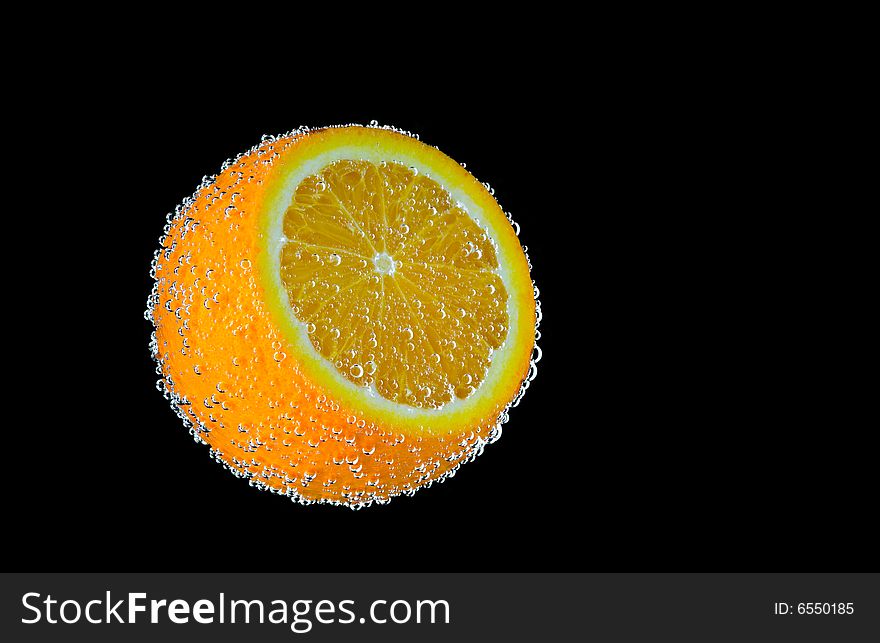 Close up view of fresh bubbled orange on black back