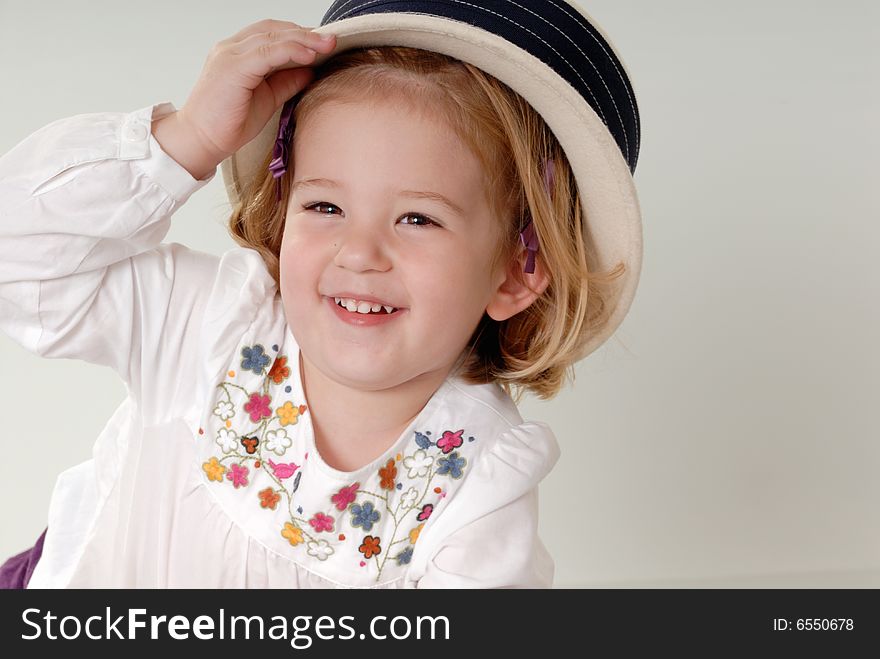 Little girl playing with hat