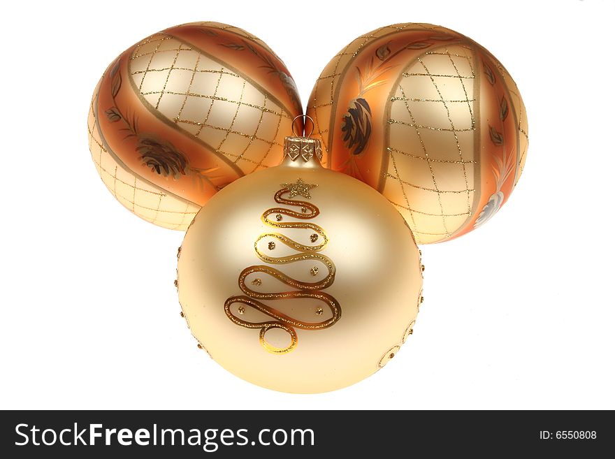 Three golden Christmas baubles isolated on white background.
