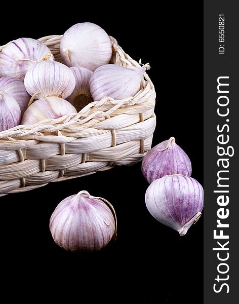 Wonderful garlic in little basket isolated on black. Wonderful garlic in little basket isolated on black.