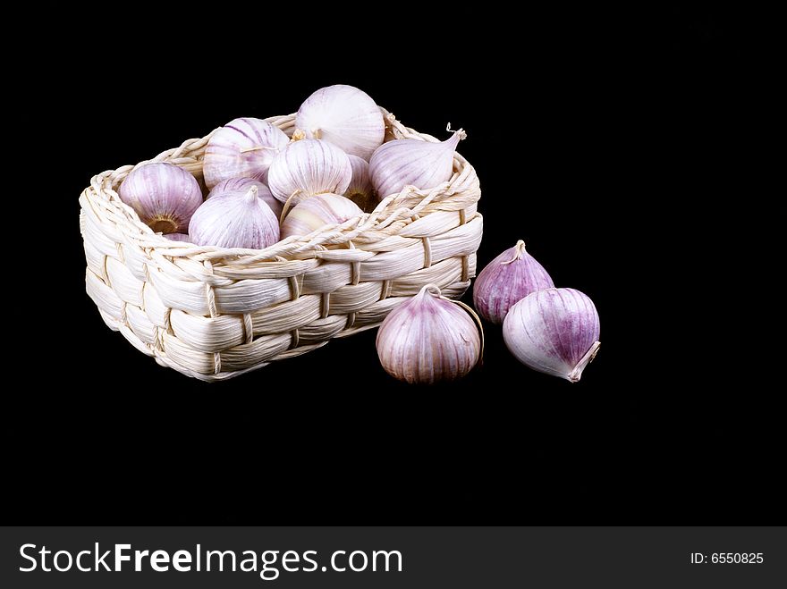 Basket full of garlic isolated on a black background. Basket full of garlic isolated on a black background.