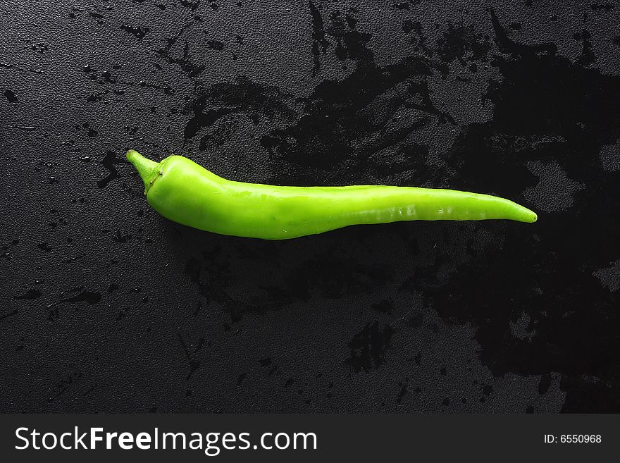 Green peppers on a dark background