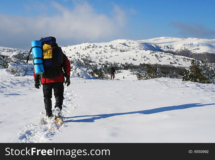 Backpacker in winter mountain, Crimea