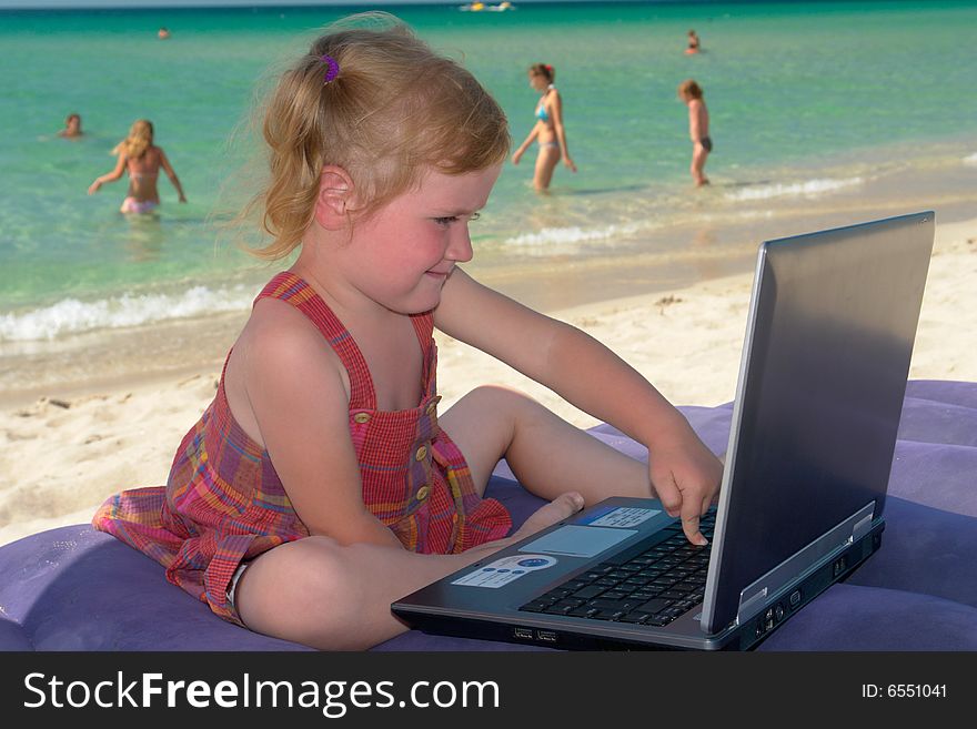 Girl with computer on a background of the sea