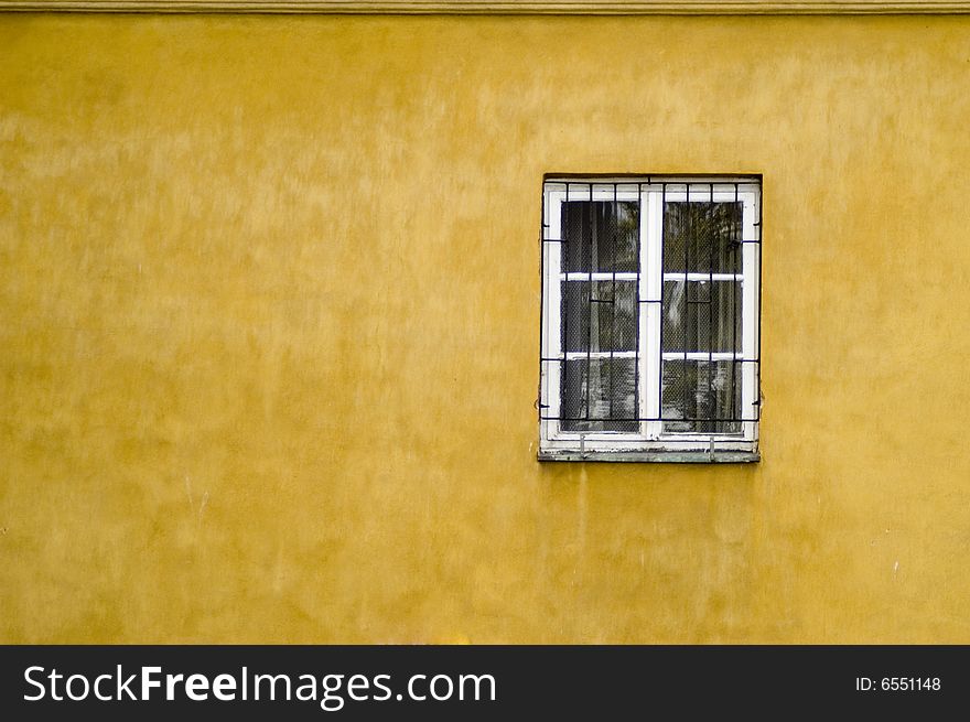 Window on a yellow wall