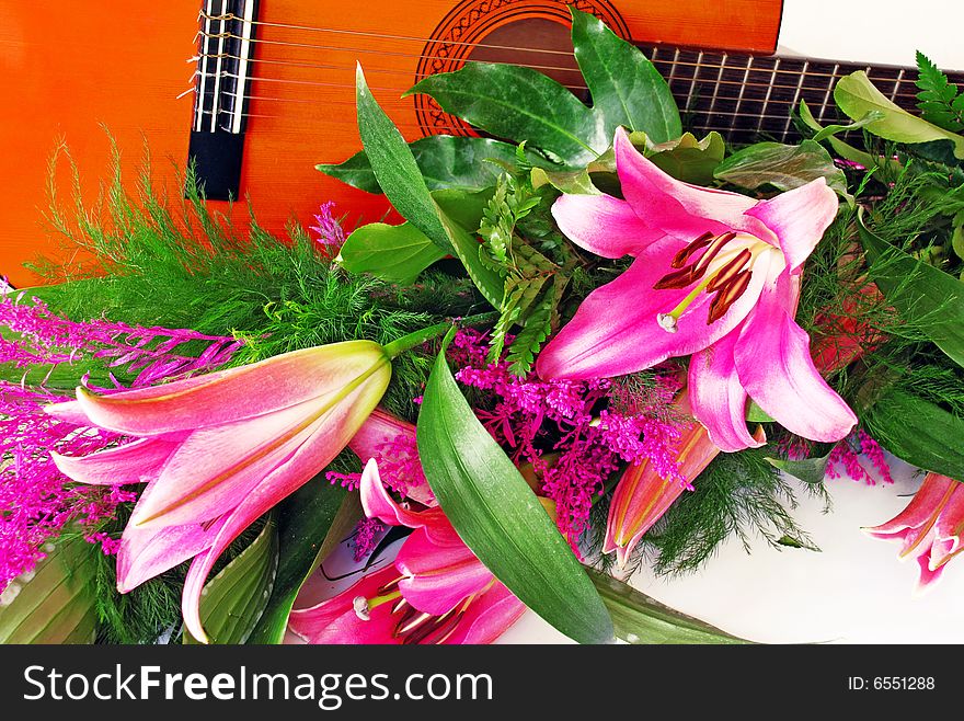 Pink lily and guitar composition over white. Pink lily and guitar composition over white
