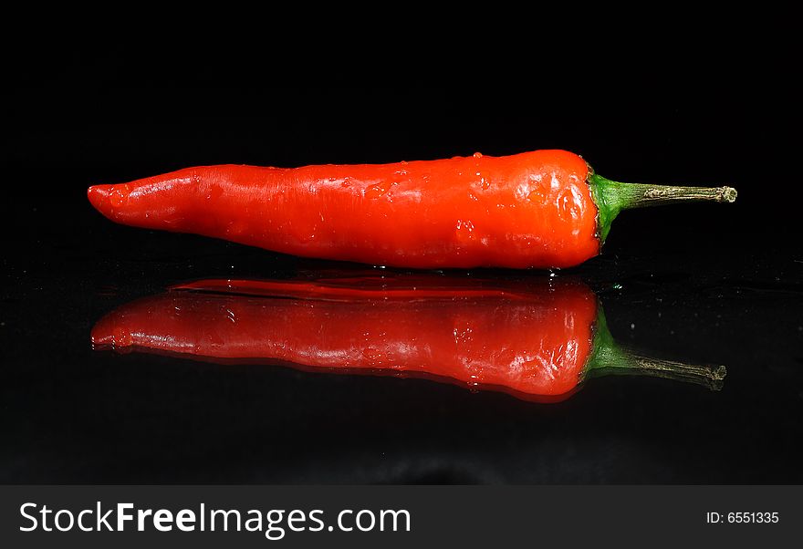 Red peppers on a dark background