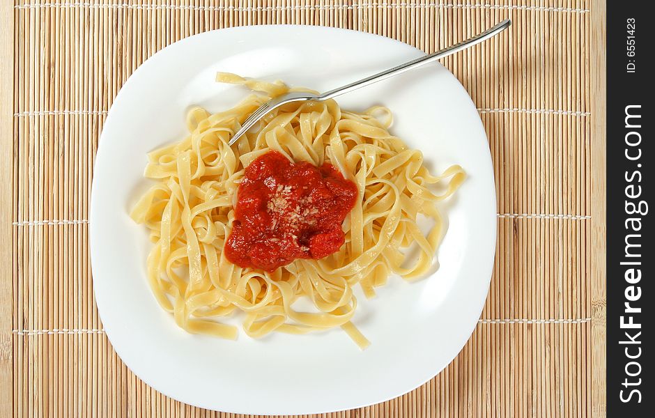 Spaghetti served on white plate