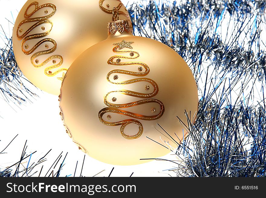 Two golden Christmas baubles isolated on white background.