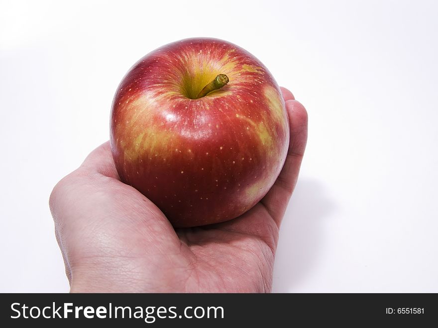 Red apple in hand isolated on white background