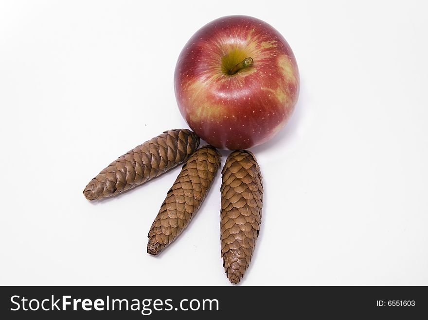 Red apple with fur-tree cones