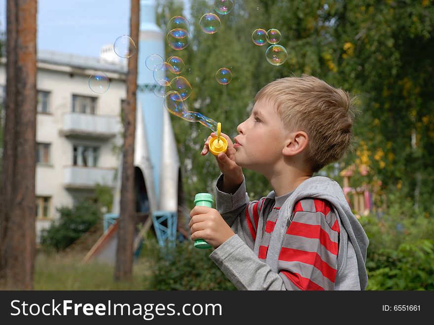 Boy with soap bubbles, outdoors